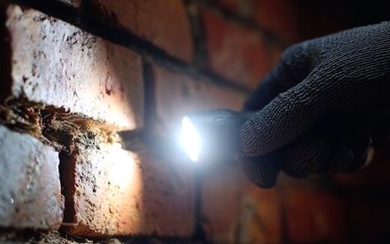 Joint checked by lamplight during leak work